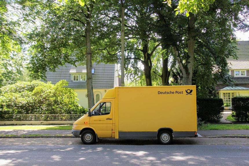 A yellow Deutsche Post Mercedes-Benz Sprinter van