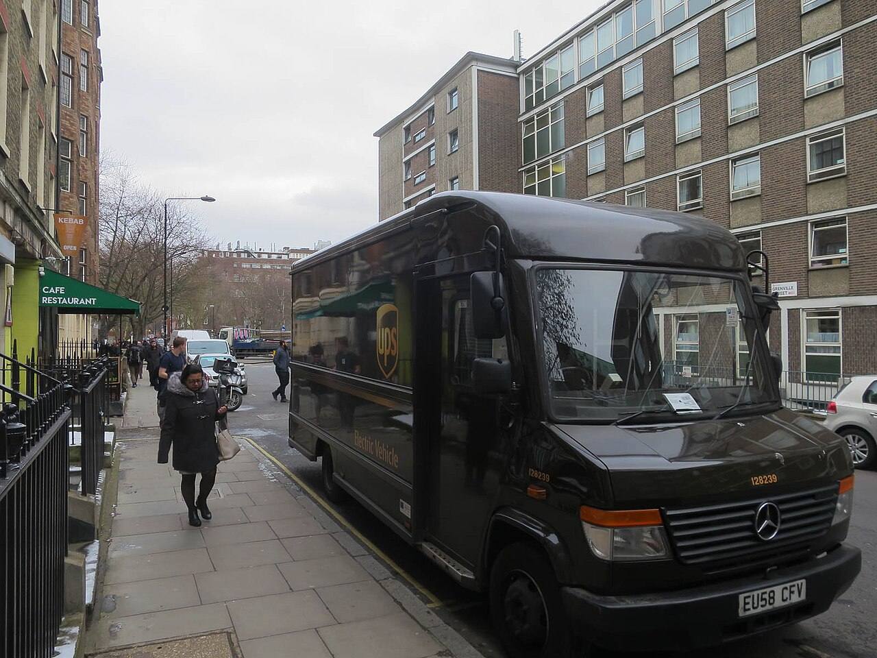 A brown UPS delivery van on a street in the UK